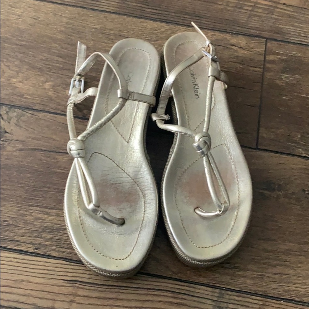 Calvin Klein Thong Sandal. Gold finish, size 8.